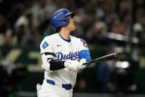 Los Angeles Dodgers' Shohei Ohtani follows through on a solo home run in the fifth inning of an ...
