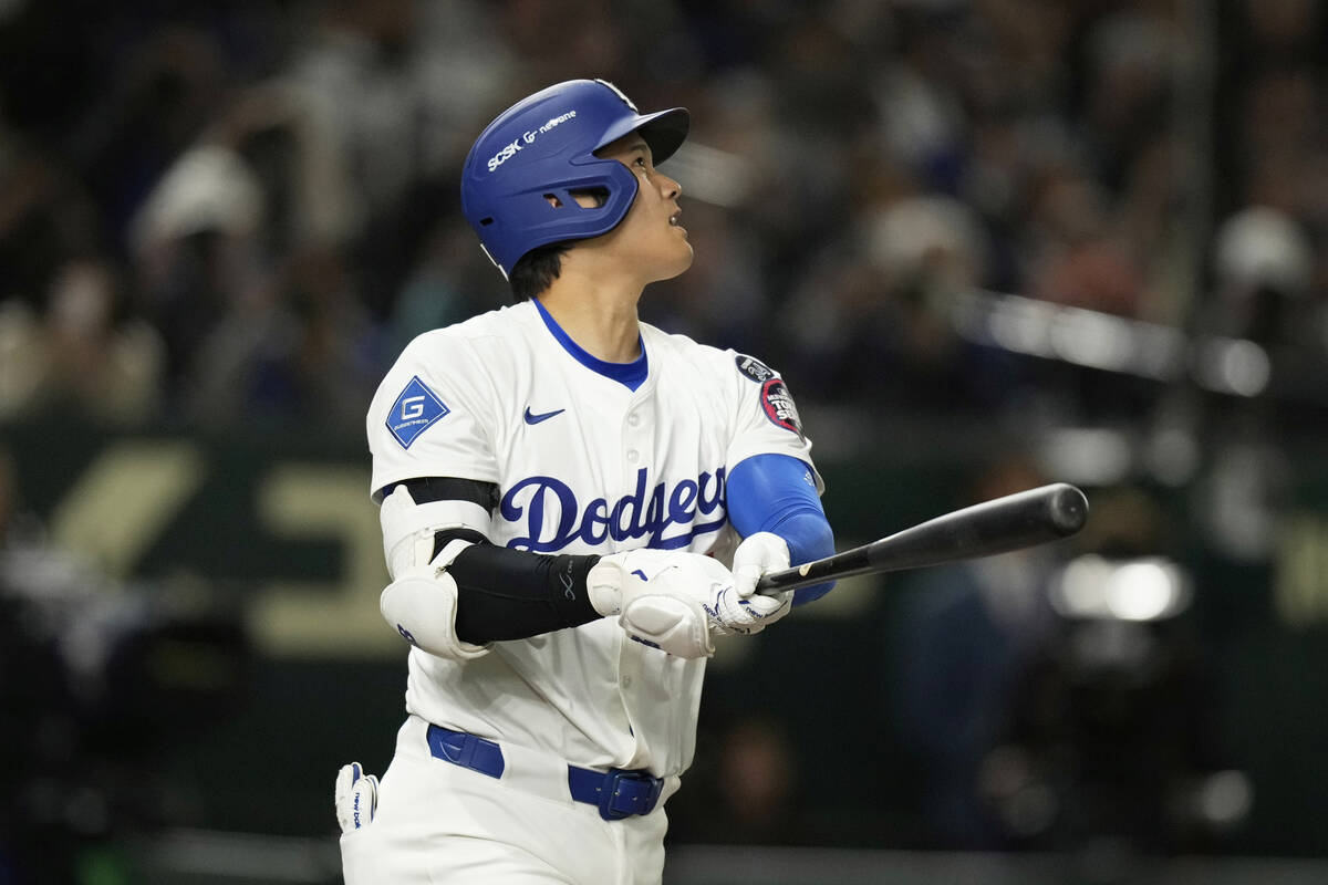 Los Angeles Dodgers' Shohei Ohtani follows through on a solo home run in the fifth inning of an ...