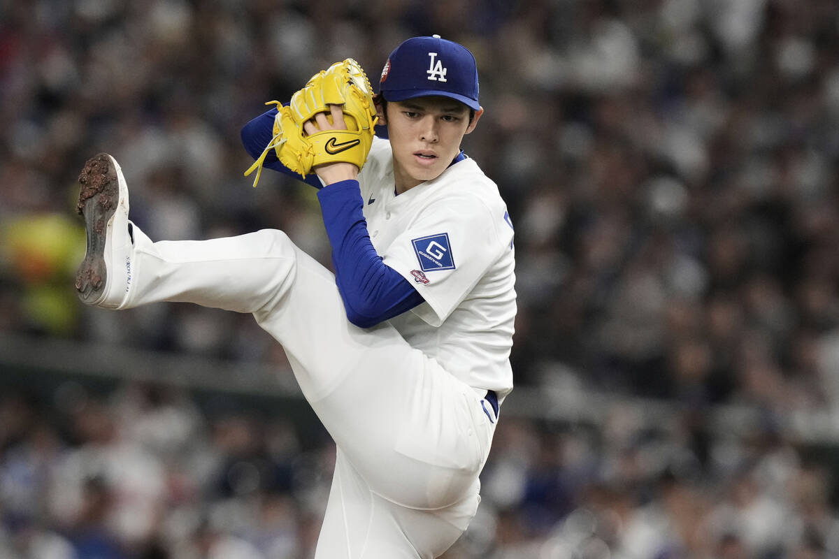 Los Angeles Dodgers starting pitcher Roki Sasaki winds up to deliver to the Chicago Cubs in the ...