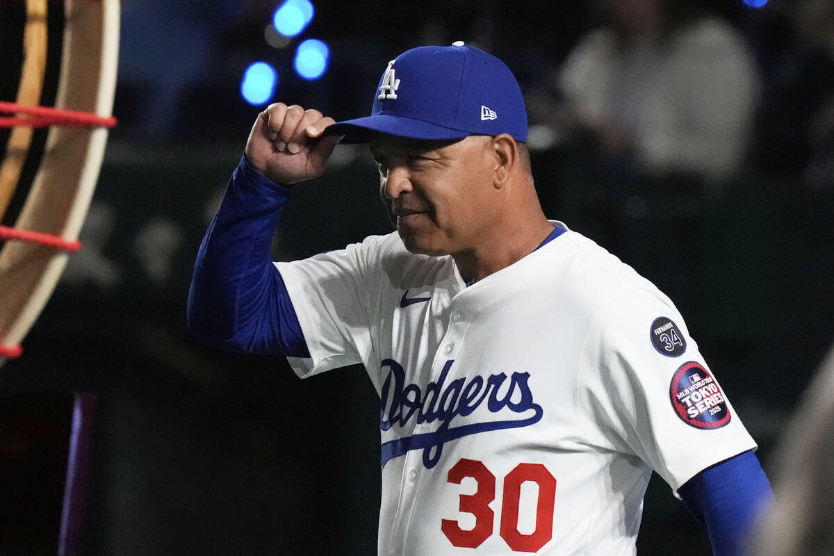 Los Angeles Dodgers manager Dave Roberts walks on to the field during team introductions before ...