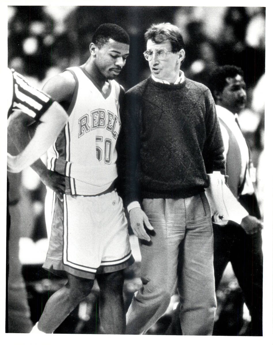 Greg Anthony talks with coach Tim Grgurich as they leave the floor at halftime against Long Bea ...