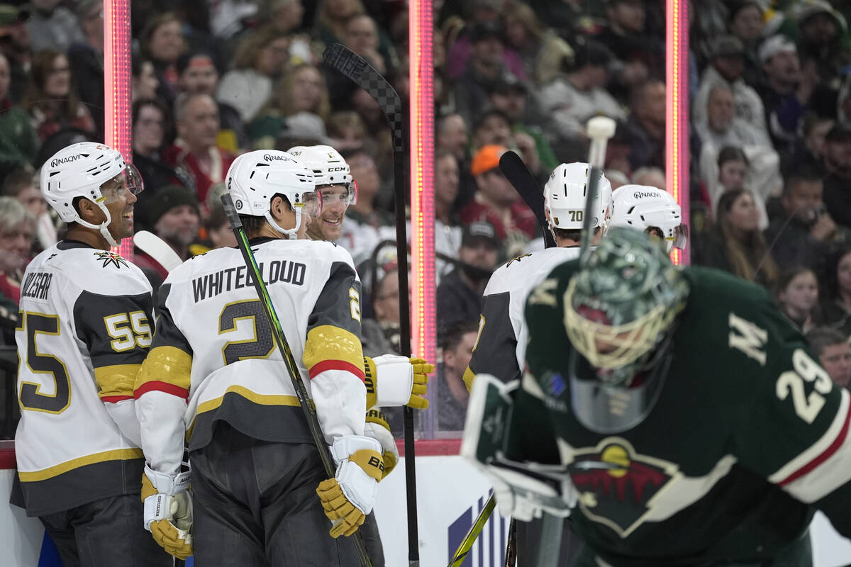 Vegas Golden Knights players celebrate after a goal by center Brett Howden, back right, during ...