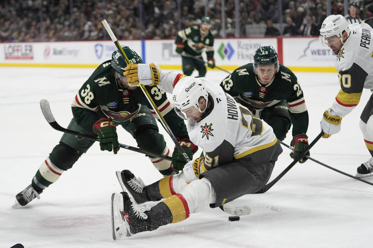 Vegas Golden Knights center Brett Howden (21) falls while reaching for the puck during the thir ...