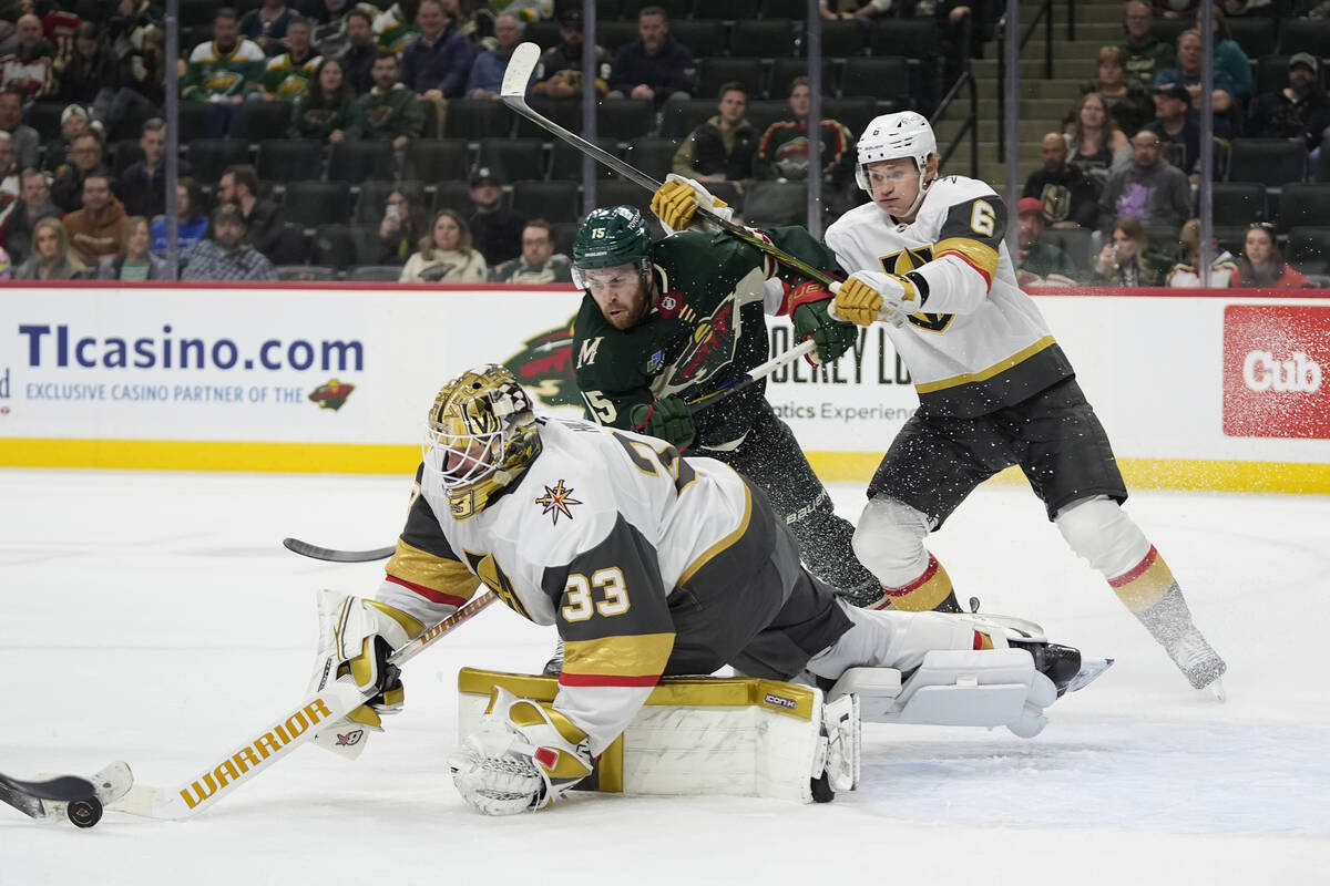 Vegas Golden Knights goaltender Adin Hill (33) reaches for the puck as Minnesota Wild right win ...