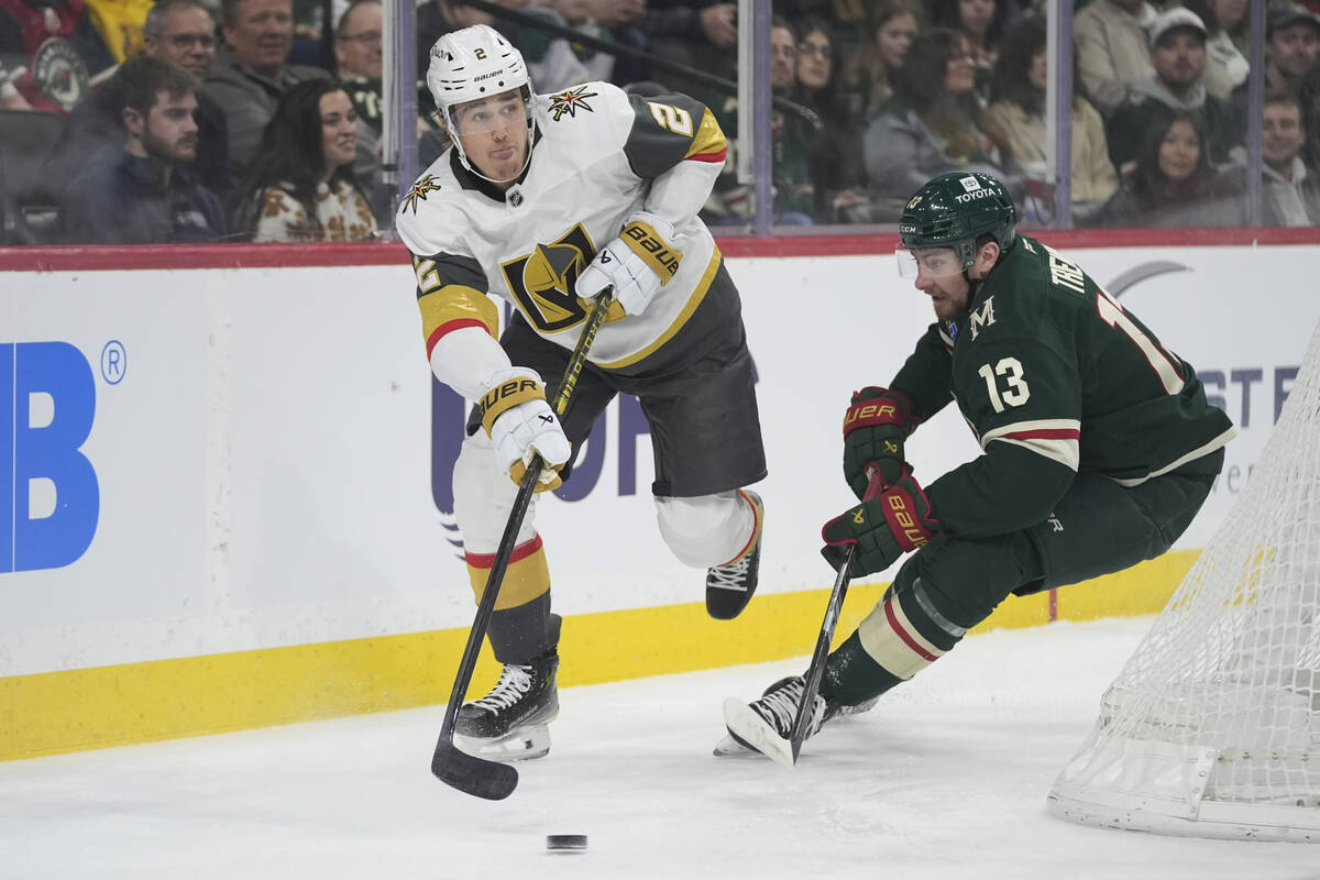 Vegas Golden Knights defenseman Zach Whitecloud (2) skates with the puck as Minnesota Wild cent ...