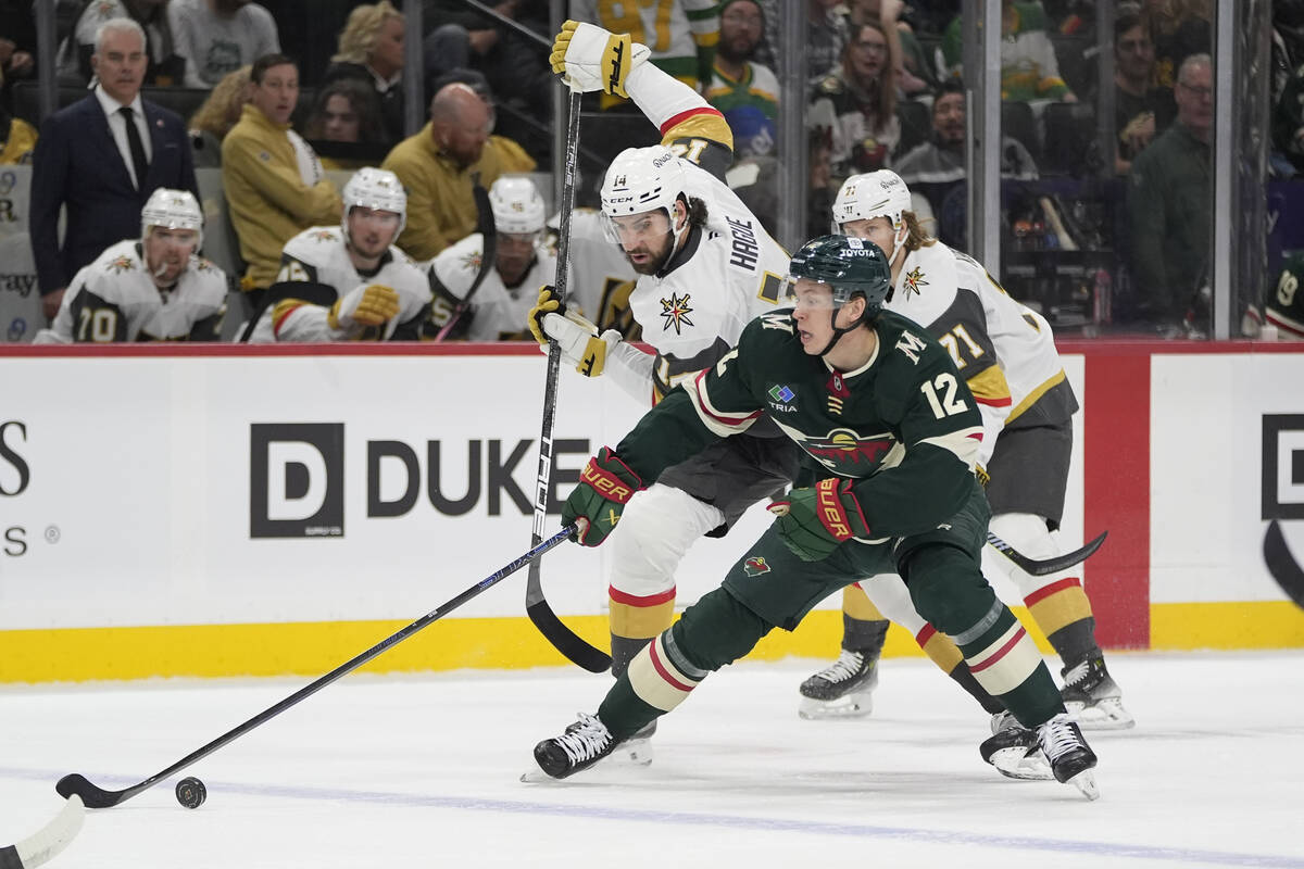 Vegas Golden Knights defenseman Nicolas Hague (14) and Minnesota Wild left wing Matt Boldy (12) ...
