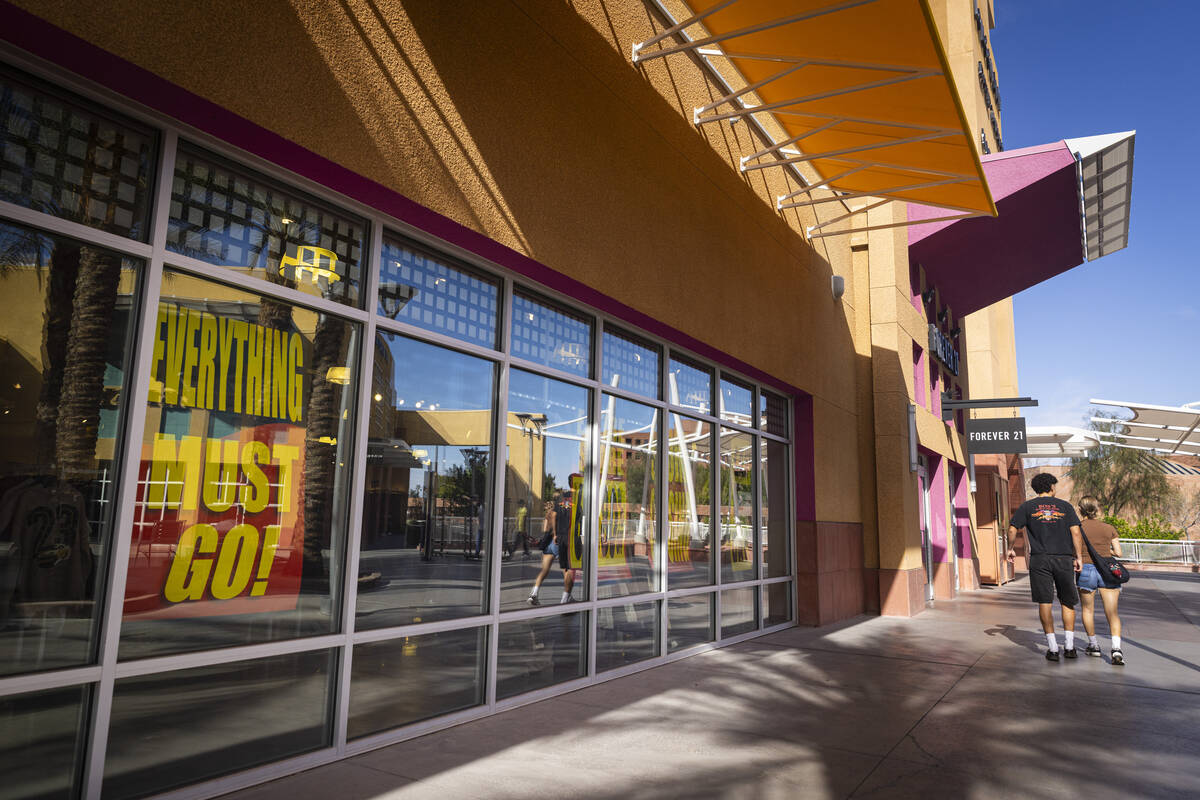 Going out of business signage is seen on display at Forever 21 as people make their way to the ...