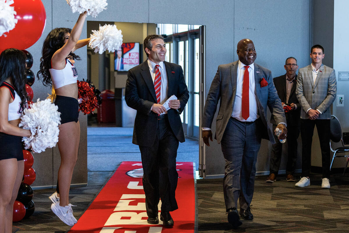 New UNLV men's basketball coach Josh Pastner walks into the room with Director of Athletics Eri ...
