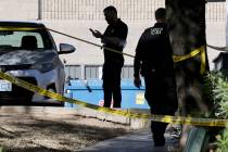 Metropolitan Police Department officers investigate the scene at an apartment complex on Channe ...