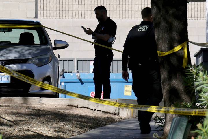 Metropolitan Police Department officers investigate the scene at an apartment complex on Channe ...
