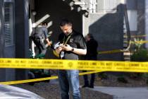 Metropolitan Police Department officers investigate the scene at an apartment complex on Channe ...