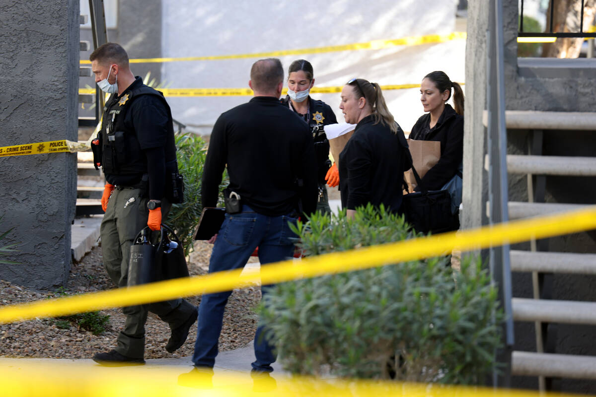 Metropolitan Police Department officers investigate the scene at an apartment complex on Channe ...