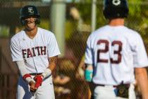 Faith Lutheran infielder Kingston Kela (2) smiles as he gets ready to walk to first base during ...