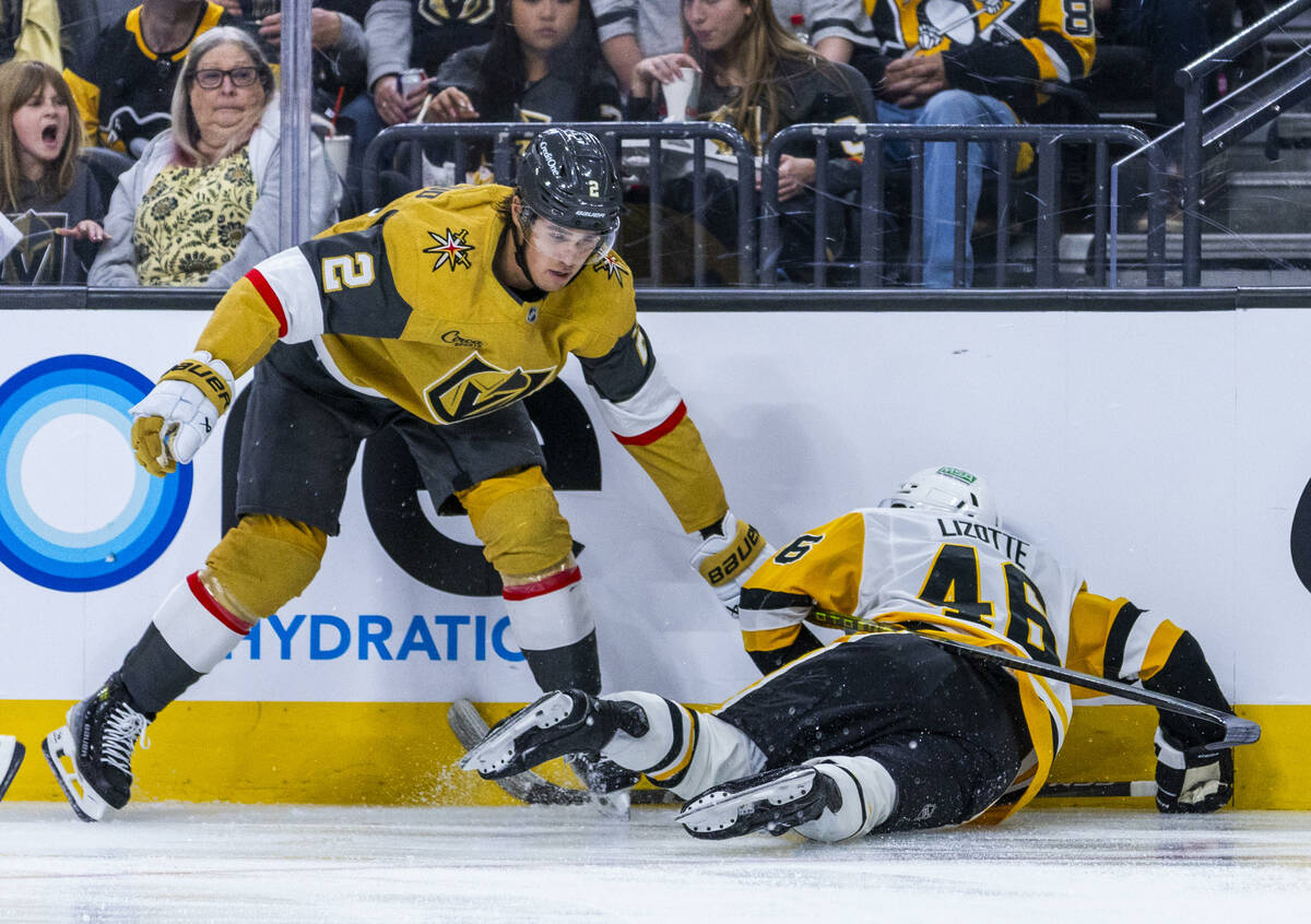 Golden Knights defenseman Zach Whitecloud (2) ensures that Pittsburgh Penguins center Blake Liz ...