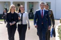 Defense Secretary Pete Hegseth, second from right, walks outside the Oval Office at the White H ...