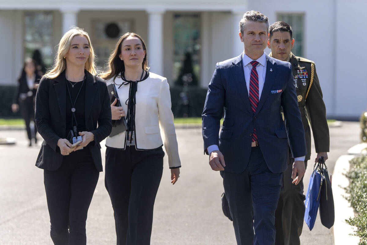 Defense Secretary Pete Hegseth, second from right, walks outside the Oval Office at the White H ...