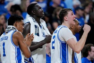 From left, Duke guard Caleb Foster (1), center Khaman Maluach and forward Cooper Flagg (2) reac ...