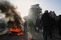 Palestinians burn tires during an anti-war protest and against Hamas in a rare show of public a ...