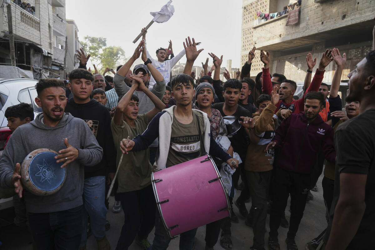 Palestinians chant slogans during an anti-war protest and against Hamas in a rare show of publi ...