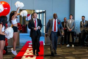 New UNLV men's basketball coach Josh Pastner walks into the room with Director of Athletics Eri ...