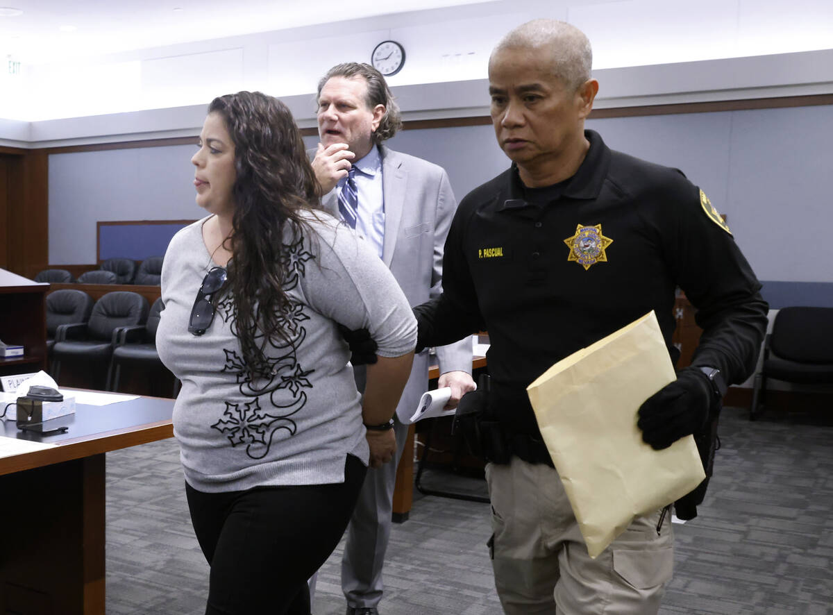 Oana Rodriguez, who pleaded guilty to a count of obtaining money under false pretenses, is led ...