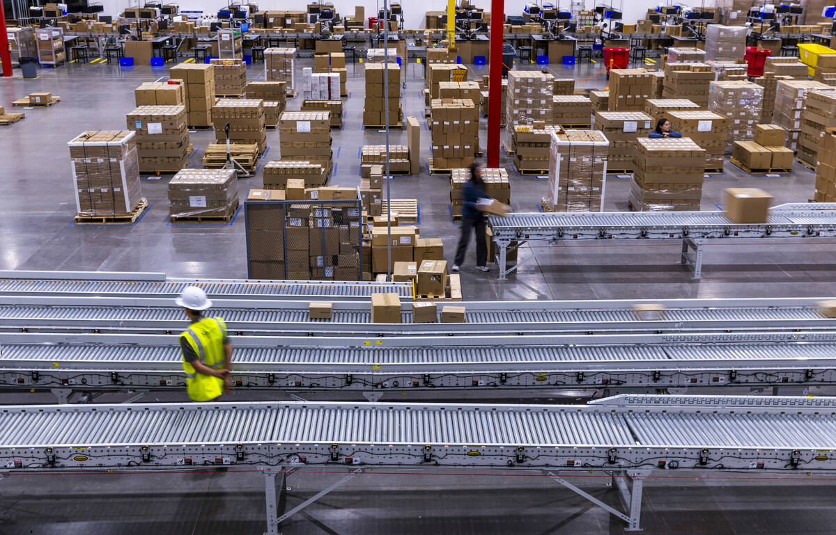 Completed boxes of products move along their sorting conveyor during a tour of the new distribu ...