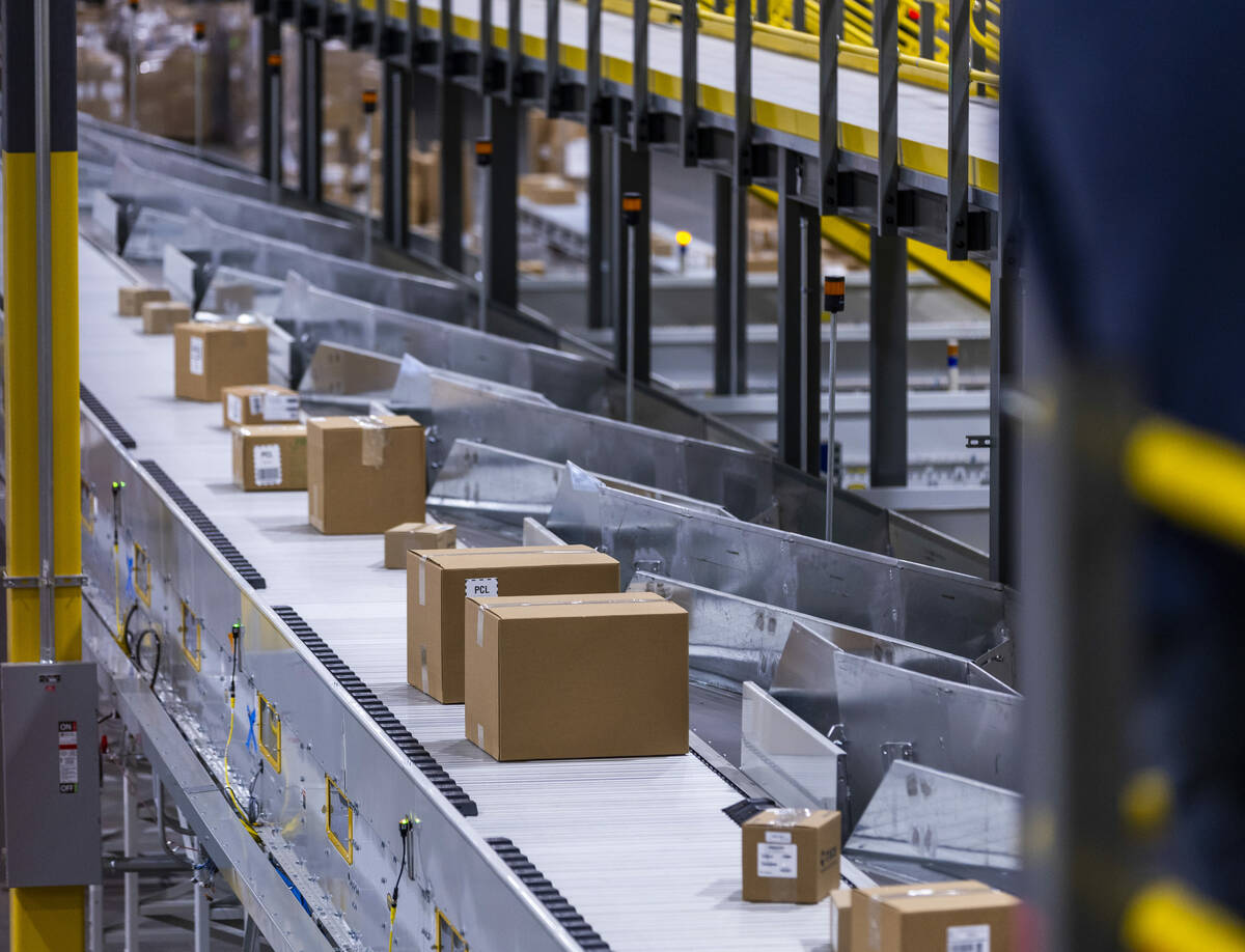 Completed boxes of products move along their sorting conveyor during a tour of the new distribu ...