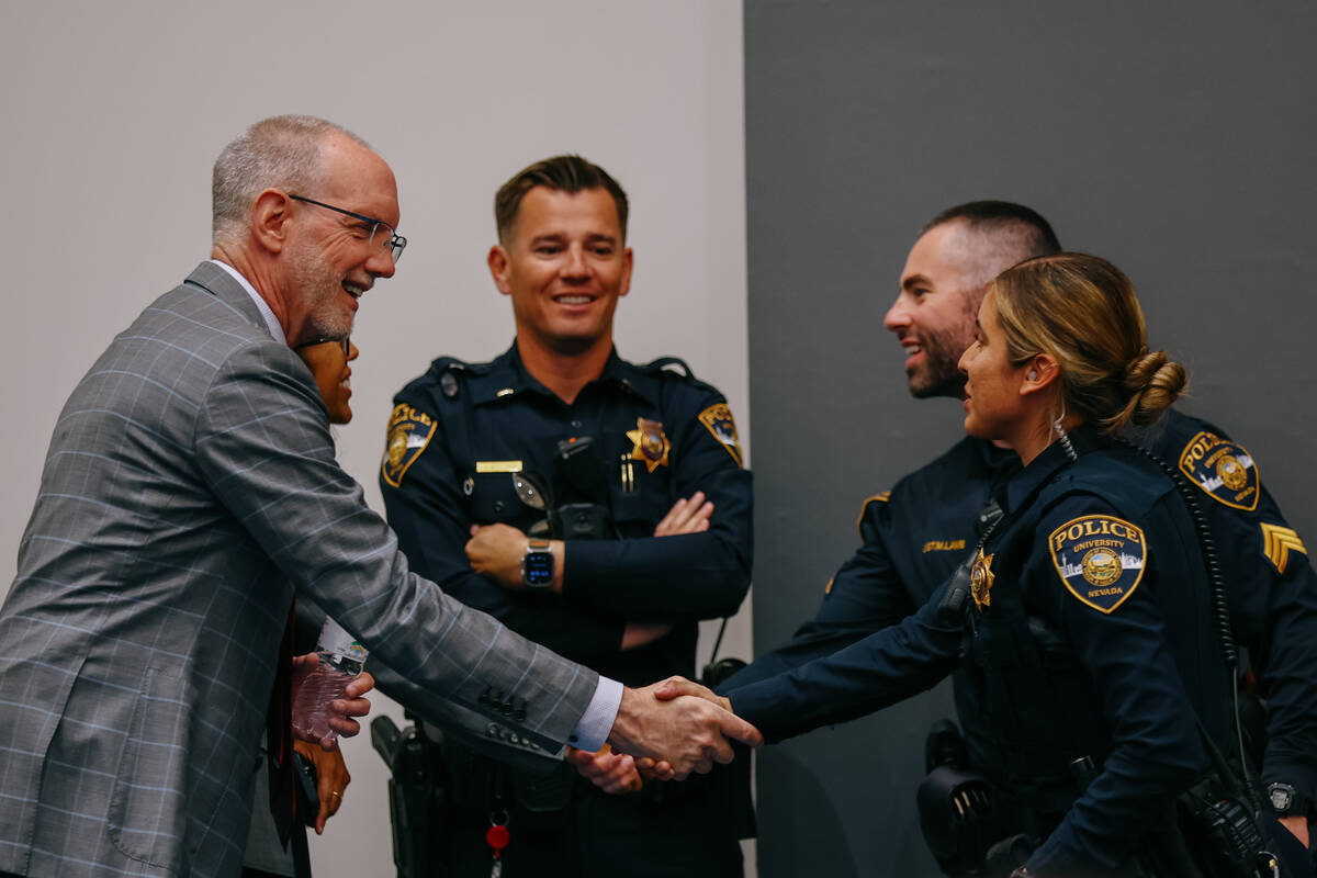 UNLV Executive Vice President and Provost Christopher Heavey shakes hands with UNLV police offi ...