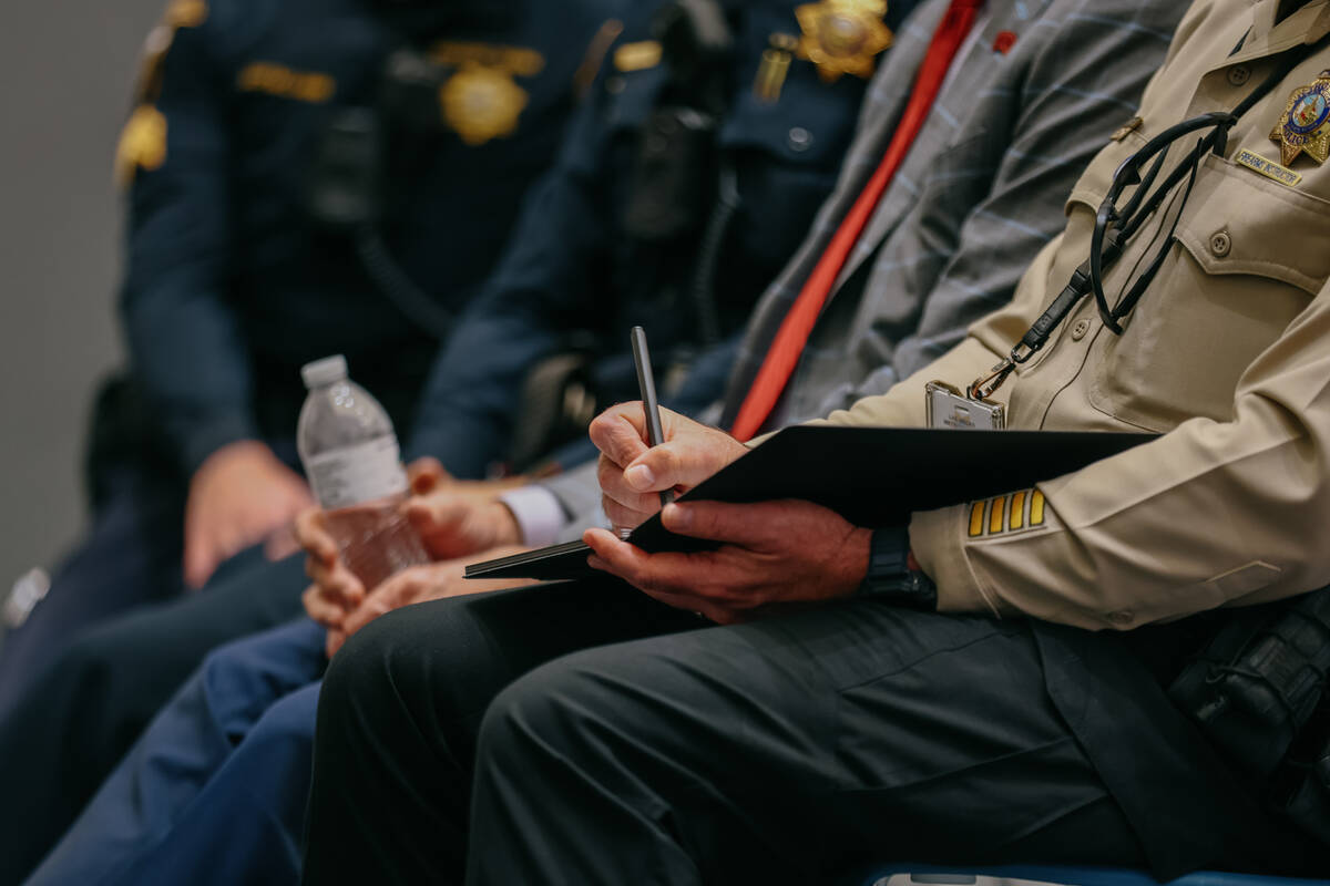 Metropolitan Police Capt. Landon Reyes takes notes during the neighborhood town hall discussing ...