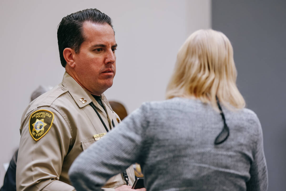 Metropolitan Police Capt. Landon Reyes listens to a community member after the neighborhood tow ...