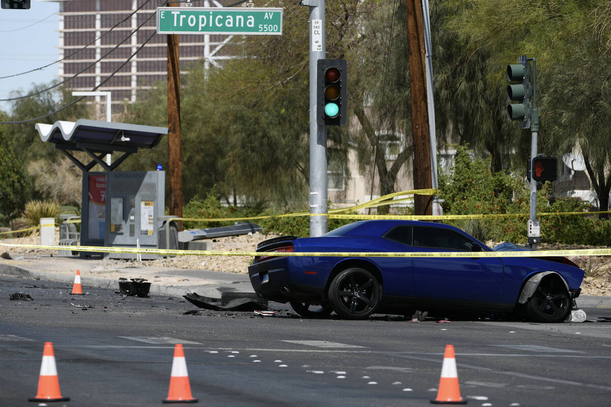 A wrecked car and bus stop are seen on Boulder Highway at Tropicana Avenue where a murder suspe ...