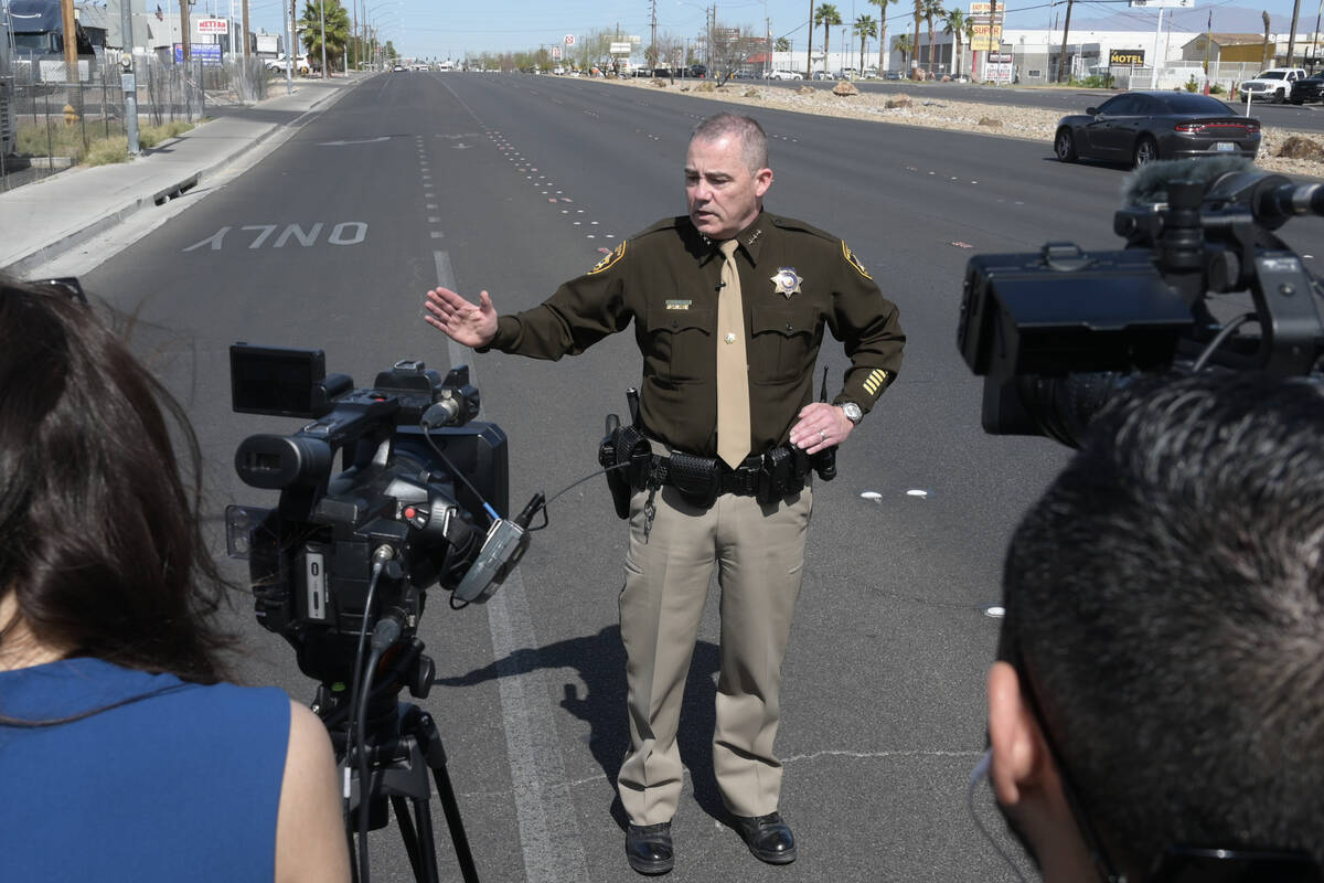 Undersheriff Andrew Walsh briefs the media at the scene where a murder suspect was apprehended ...