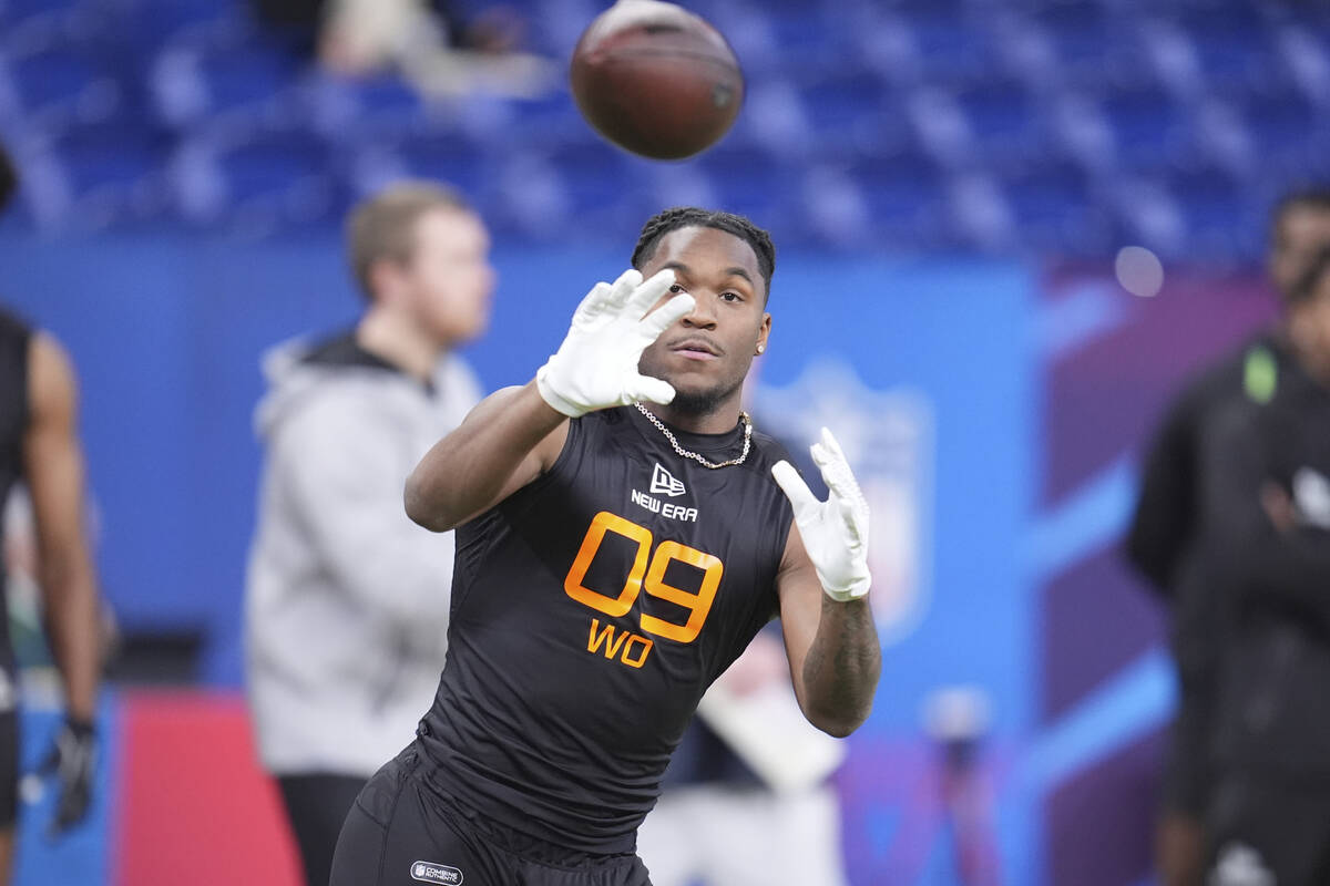 Missouri wide receiver Luther Burden III runs a drill at the NFL football scouting combine in I ...