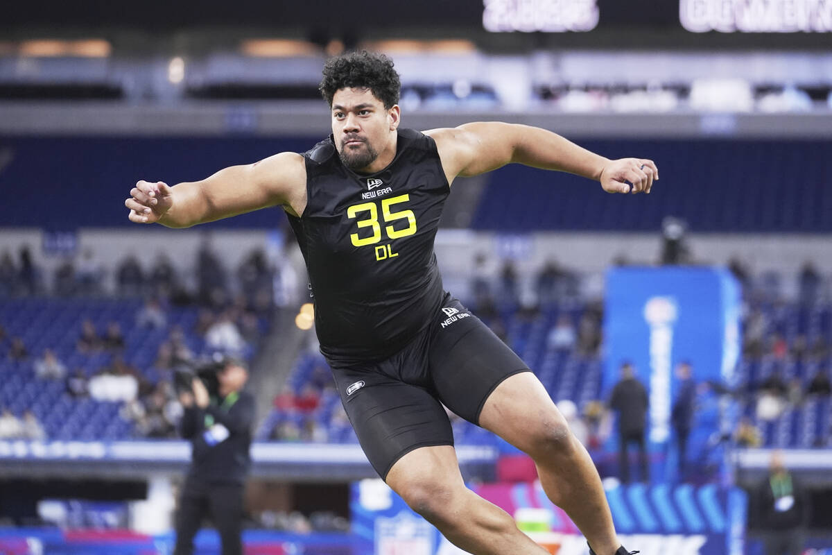 Utah defensive lineman Junior Tafuna runs a drill at the NFL football scouting combine in India ...