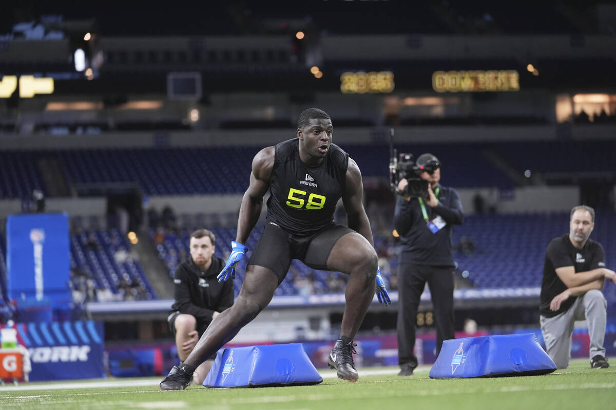UCLA defensive lineman Oluwafemi Oladejo runs a drill at the NFL football scouting combine in I ...
