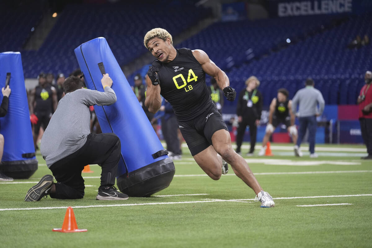 California linebacker Teddye Buchanan runs a drill at the NFL football scouting combine in Indi ...