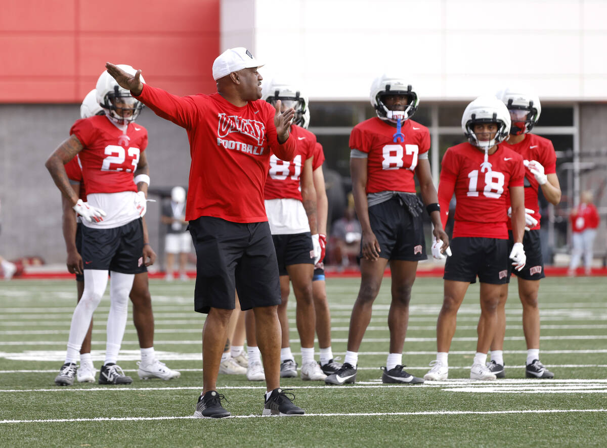 UNLV wide receivers coach Del Alexander instructs his players during team practice, on Thursday ...