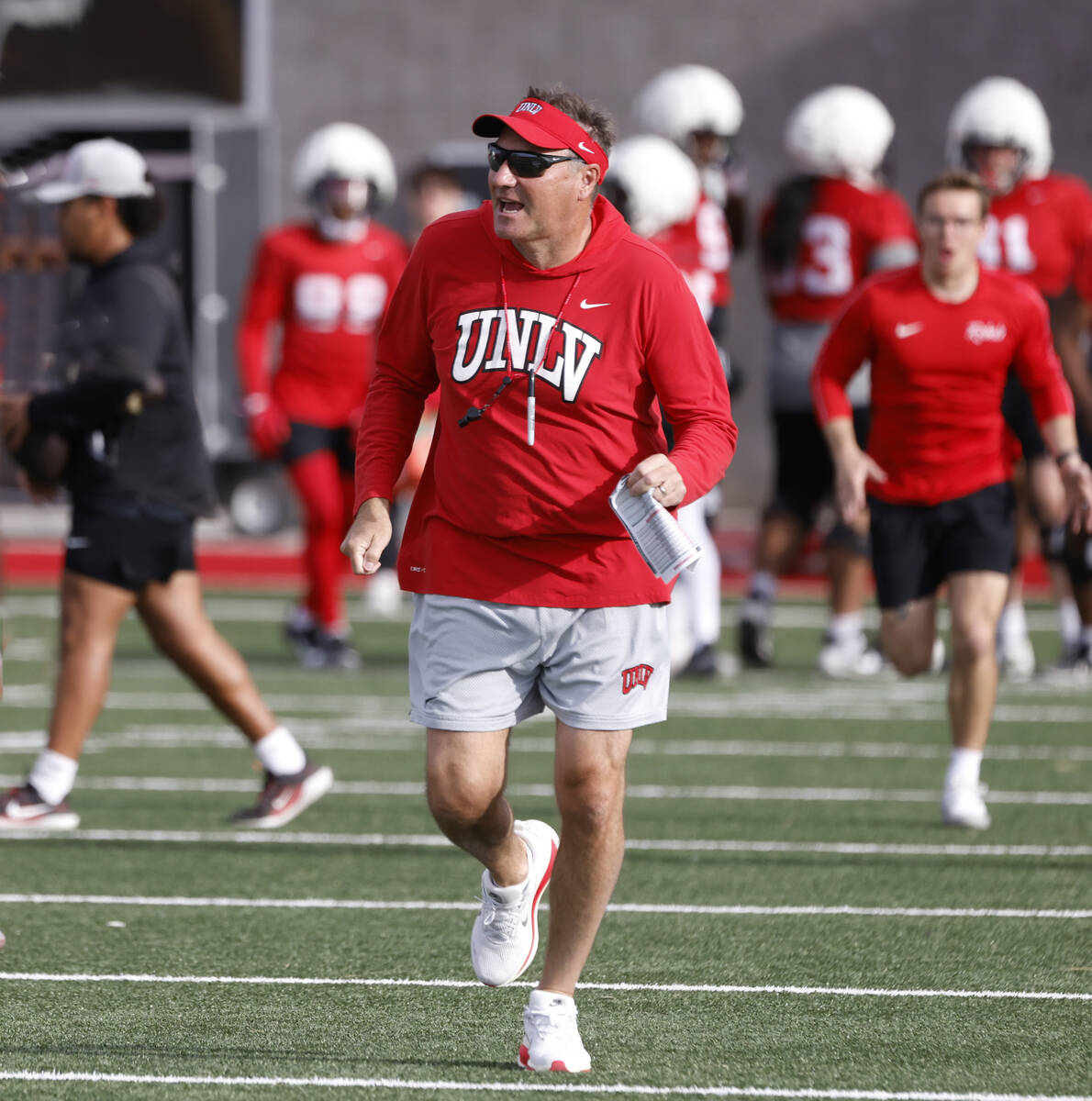 UNLV football head coach Dan Mullen leads his team as they take the field during team practice, ...