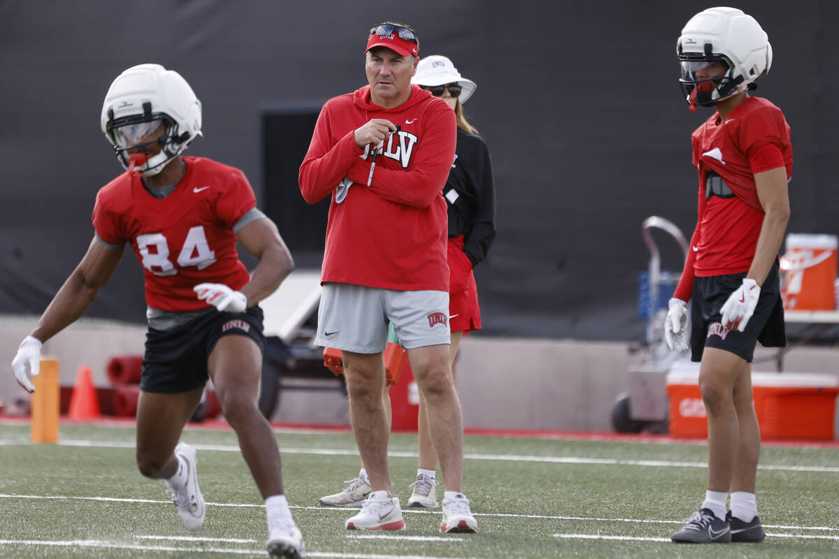 UNLV football head coach Dan Mullen, center, watches team practice, on Thursday, March 27, 2025 ...