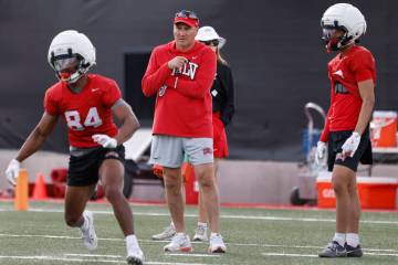 UNLV football head coach Dan Mullen, center, watches team practice, on Thursday, March 27, 2025 ...