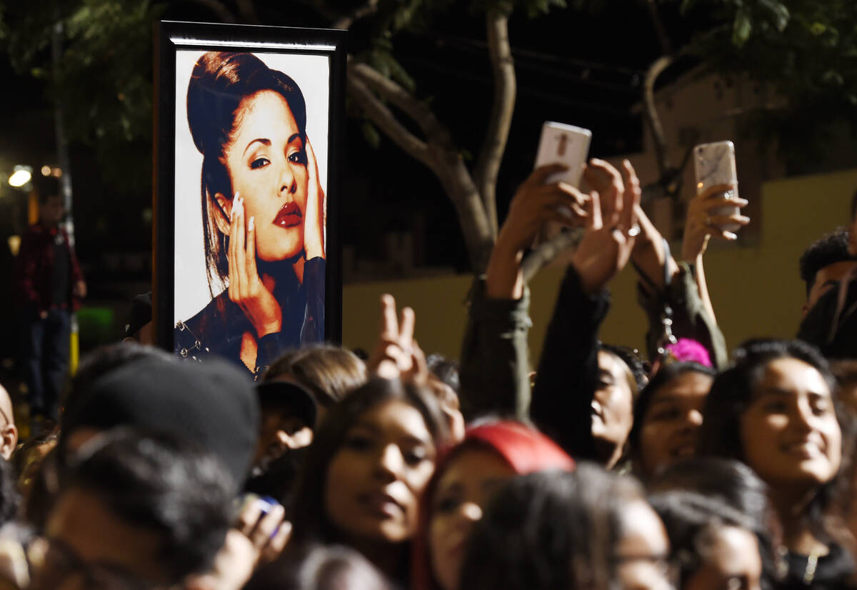 FILE - A portrait of the late singer Selena Quintanilla is seen in the crowd following a posthu ...