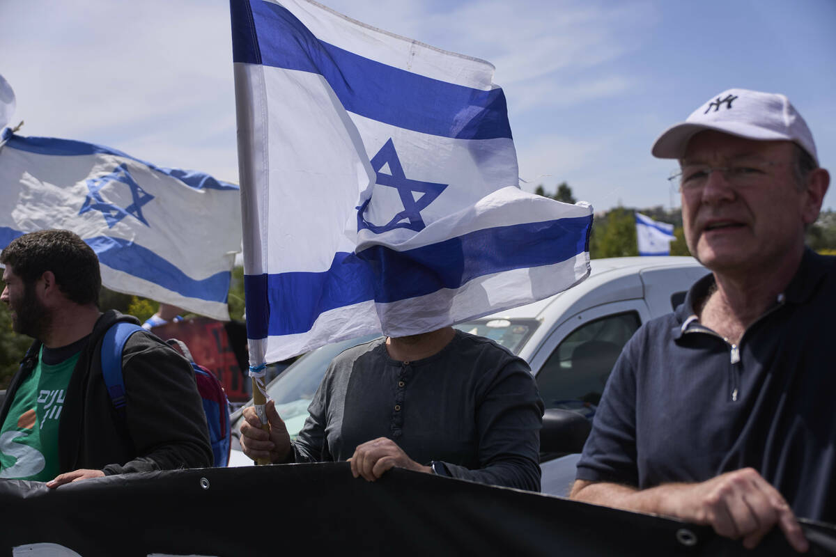 Israelis block a highway between Jerusalem and Tel Aviv in a protest against Prime Minister Ben ...