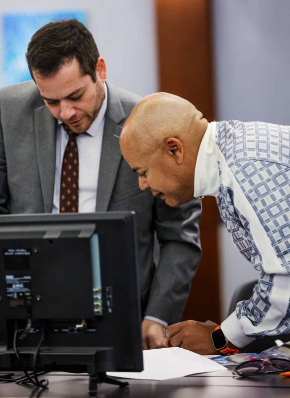 Attorney Jonathan Goldsmith, left, reviews with special administrator Malcolm LaVergne during a ...