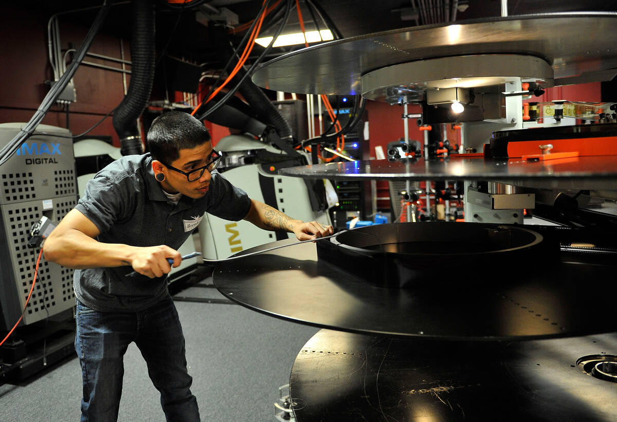 Projectionist Julian Attiya practices threading a 70mm film print at the Brenden Theatres insid ...