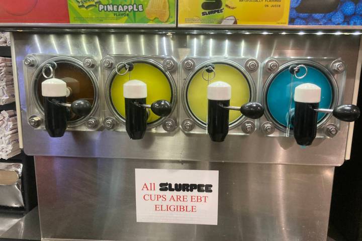 A sign below a 7-Eleven Slurpee machine states the sugary treat is eligible for EBT usage in He ...