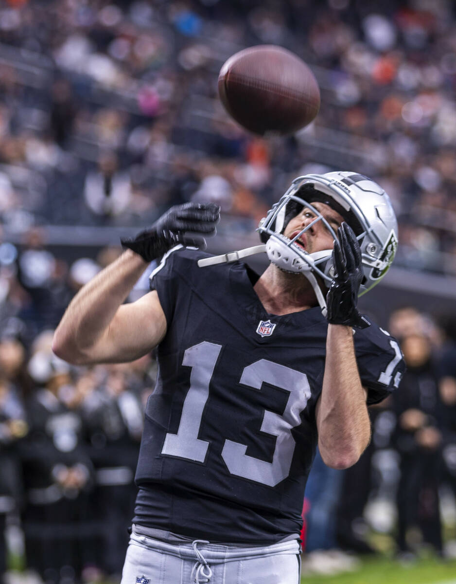 Raiders wide receiver Hunter Renfrow (13) catches a pass warming up against the Denver Broncos ...