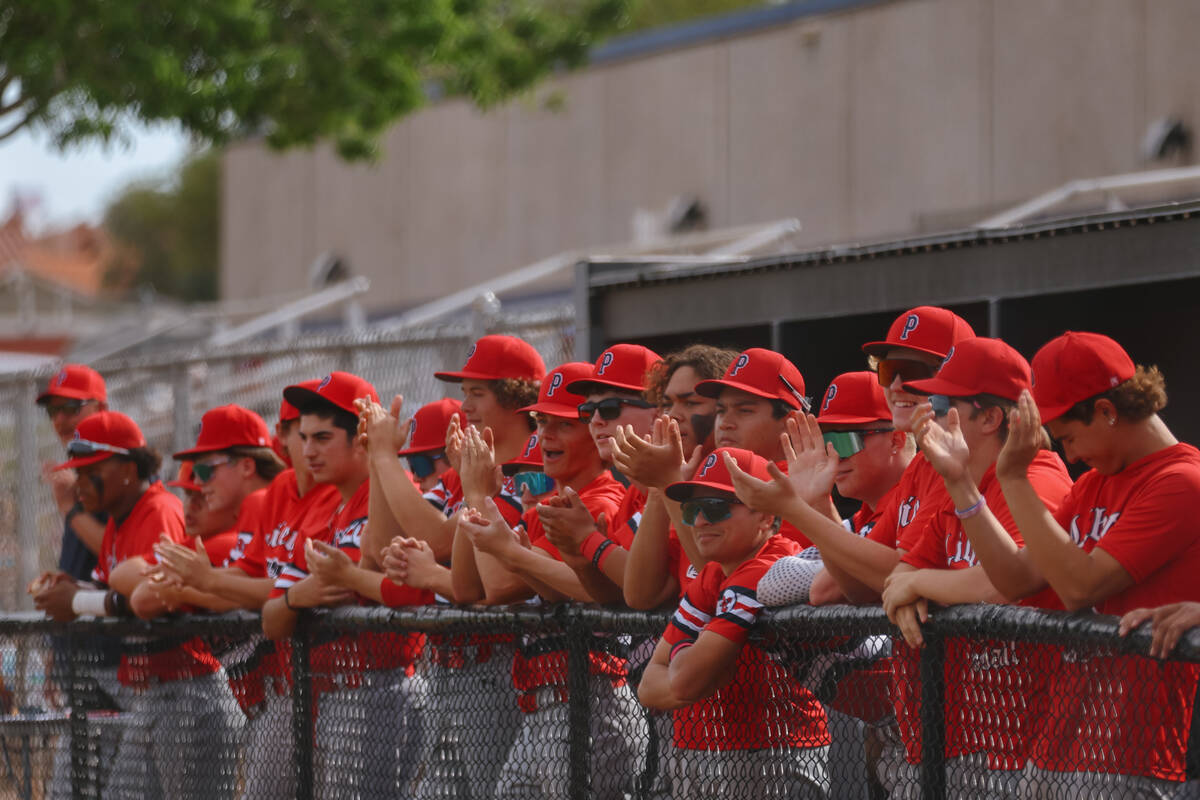 Liberty teammates clap on the dugout during the baseball game against Basic Academy on Friday, ...