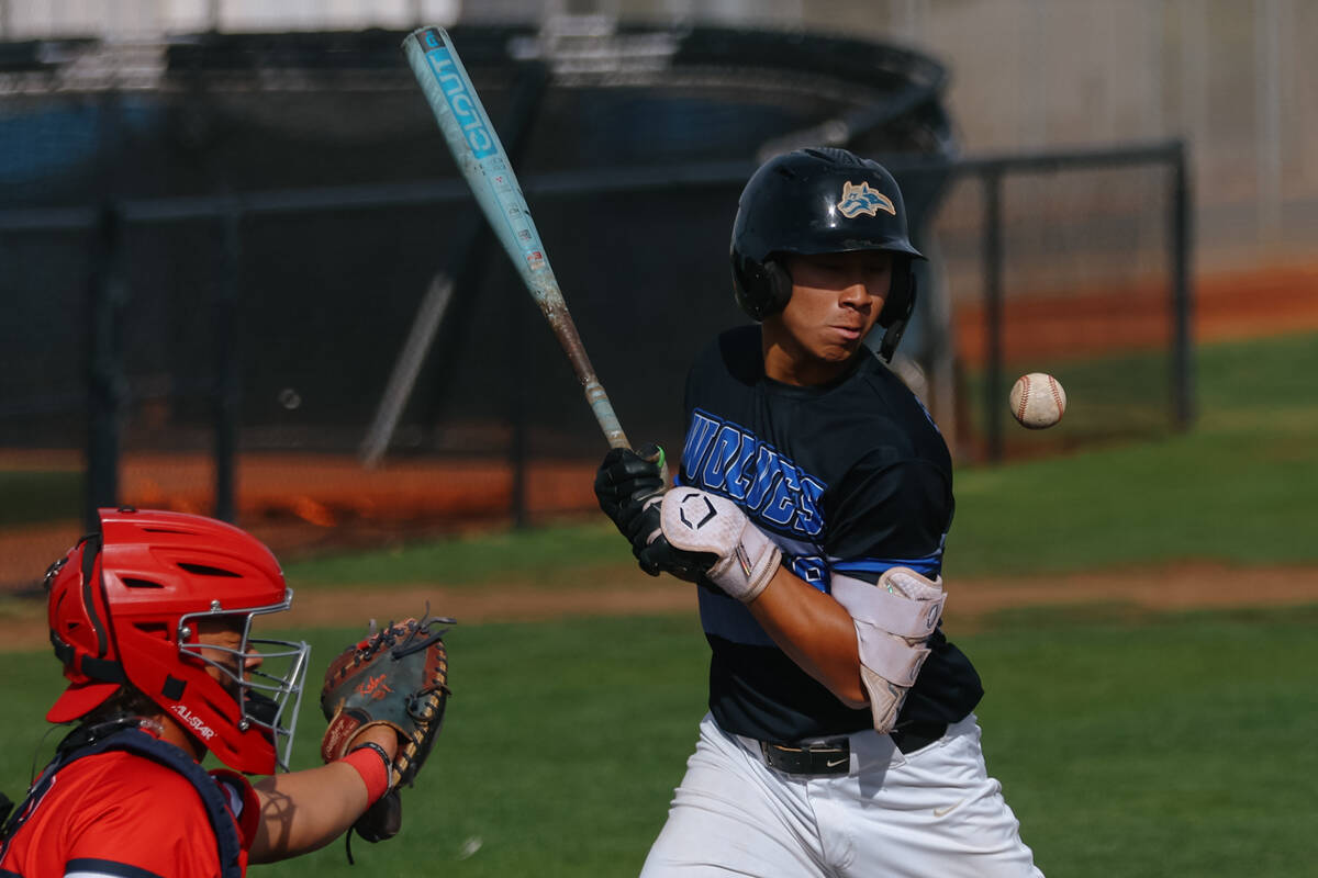 A pitch hits Basic Academy hitter Tate Southisene (8) in the shoulder, earning an automatic wal ...