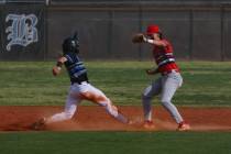 Basic Academy’s Andruw Giles (29) makes a dash back to second base after attempting a st ...