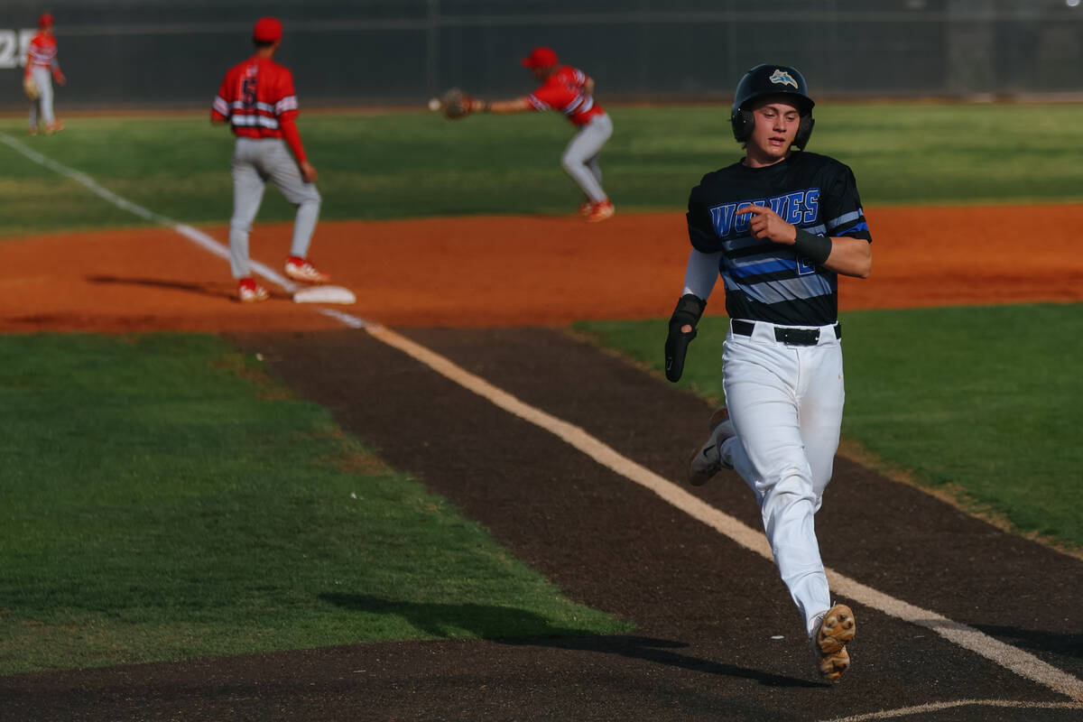 Basic Academy’s Cullen McKee (20) makes it to home plate, earning another run for the Wo ...